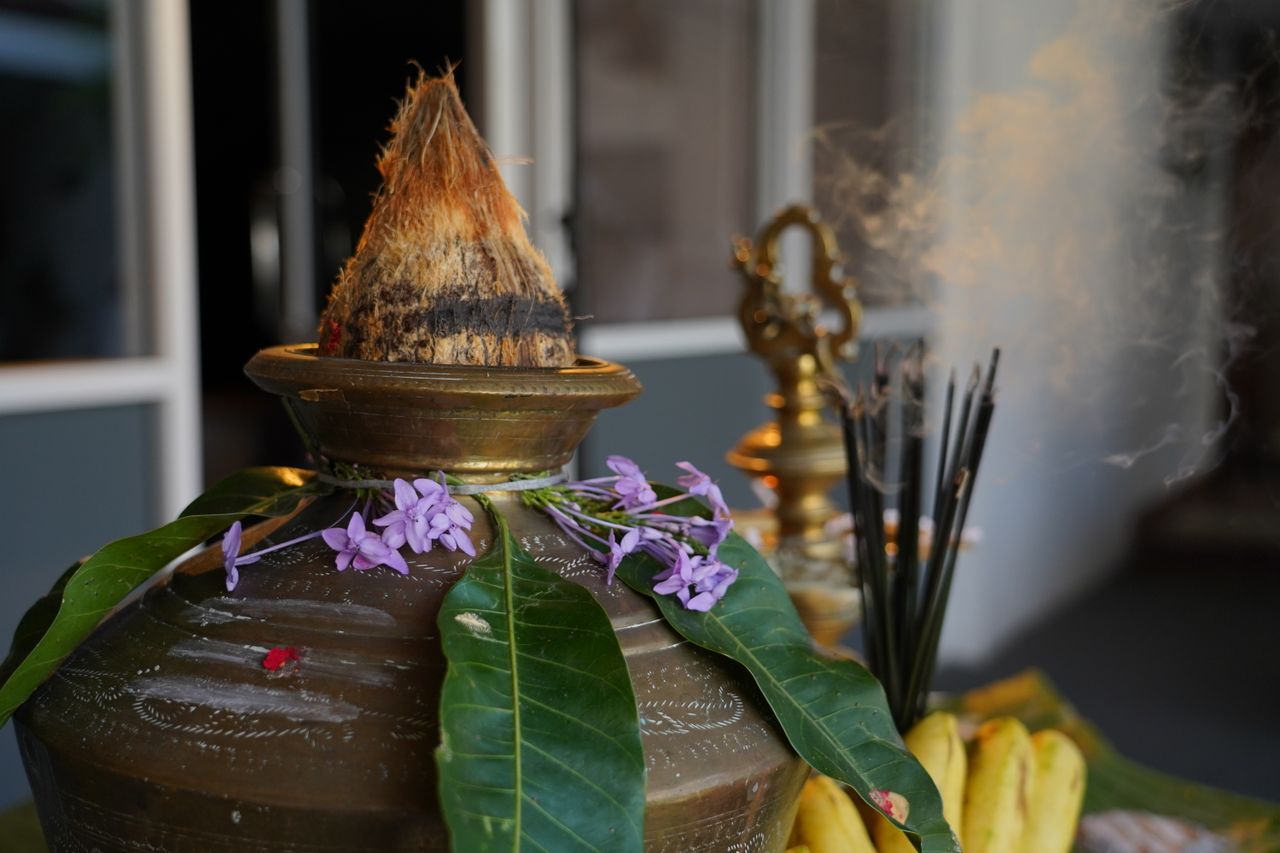 services-02 A beautiful arrangement for Pongal festival featuring a decorated pot, mango leaves, flowers, and bananas in Sri Lanka.